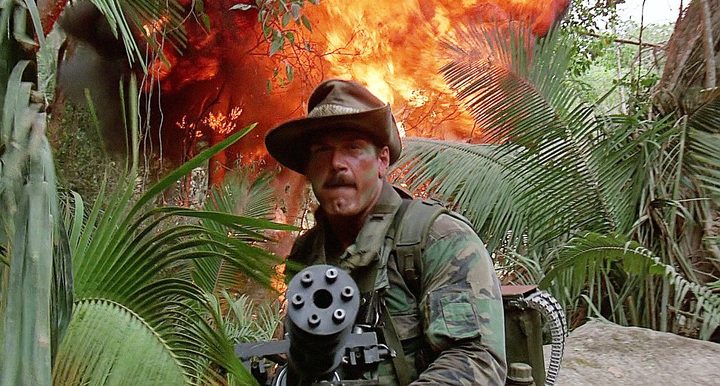 Jesse Ventura aims a gun in Predator.