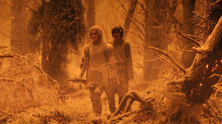 Galadriel walks in a fiery battle in The Rings of Power.