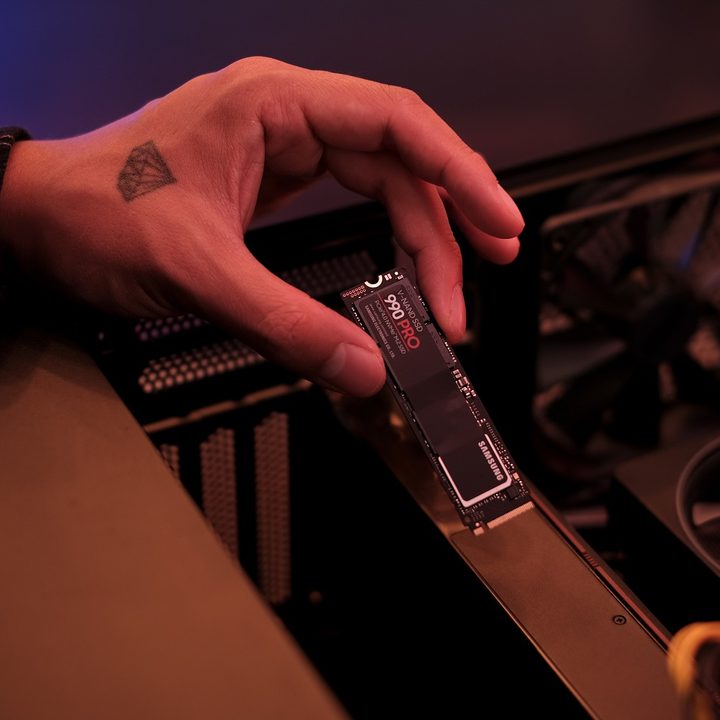 The Samsung 990 Pro SSD being installed in a PC.