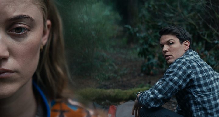 Maika Monroe stares blankly into the camera while Jake LAcy looks at her in a scene from Significant Other.