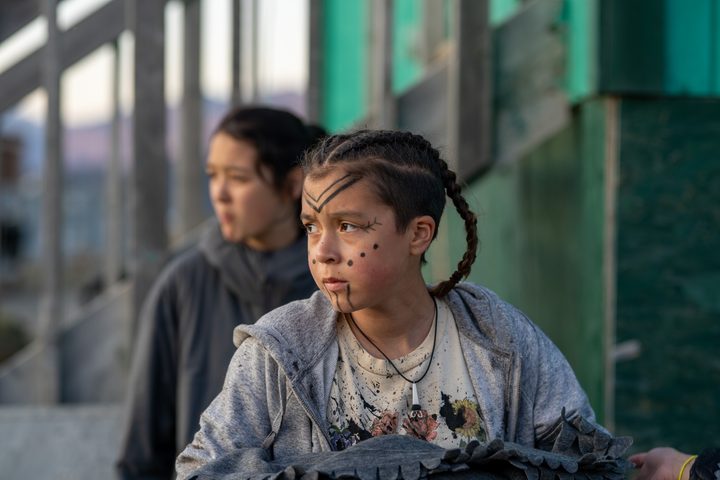 A girl wearing face paint looks off-camera in a scene from Slash/Back.