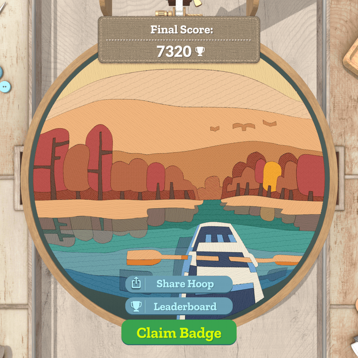 A finished embroidery hoop in the game Stitch shows a boat on a lake.