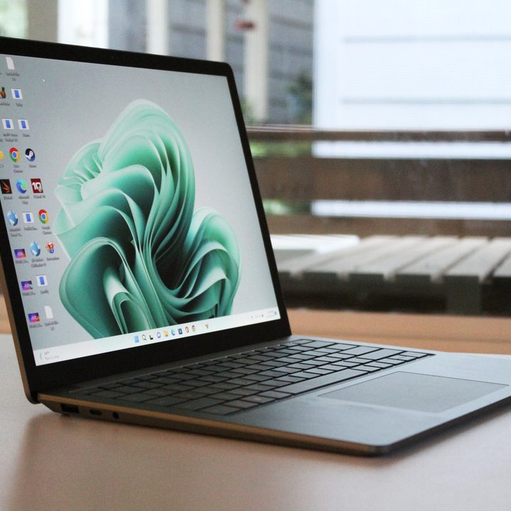 The Surface Laptop 5 on a table in front of a window.