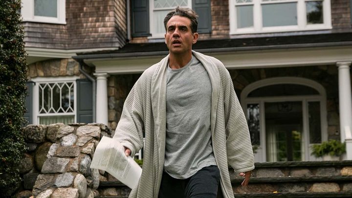 Bobby Cannevale in The Watcher standing outside his house with a letter in hand, looking scared.