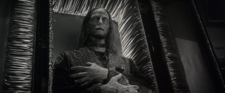 A mummified character reclins in a coffin in a scene from Werewolf By Night.