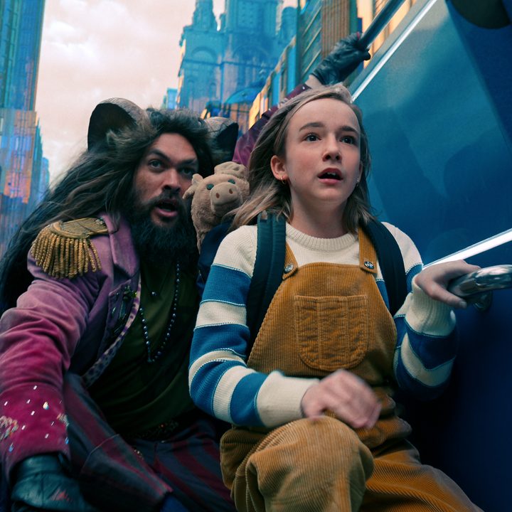 Jason Momoa and Marlow Barkley kneel beside a car in Slumberland.
