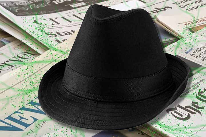 A black fedora rests on top of newspapers infected with spreading green lines..