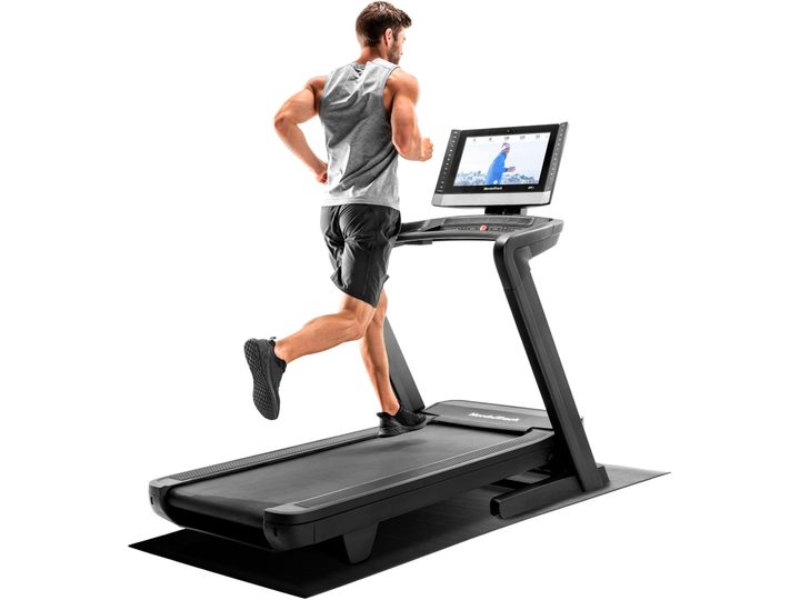 A man running on a Nordictrack Commercial 2450 Treadmill.