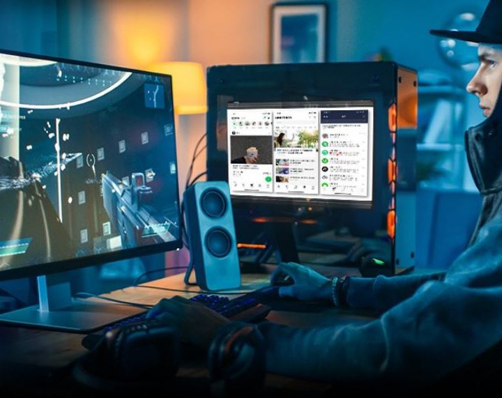 Gamer in front of a PC that has the ASRock side panel screen on it.