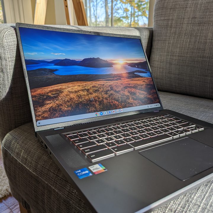 Acer 516 GE on couch screen open at max brightness.