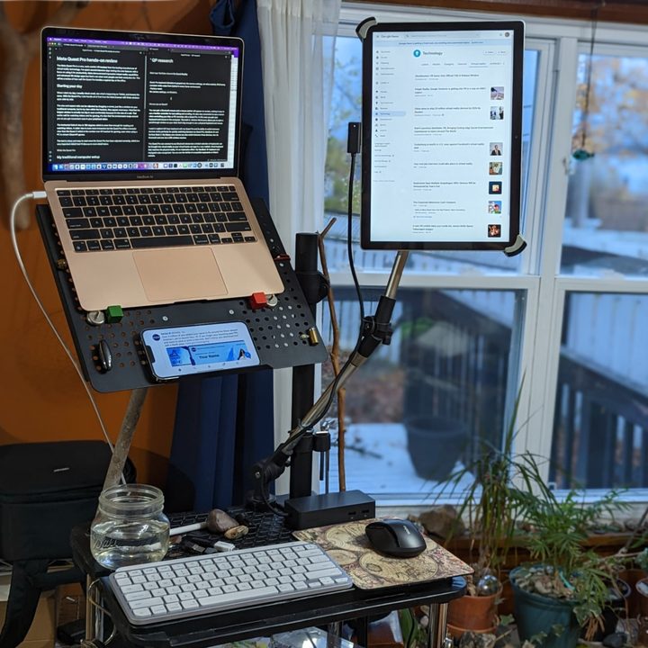 Alan Truly's standing desk has a MacBook Air, Surface Book 2, and iPhone 13 Pro Max.