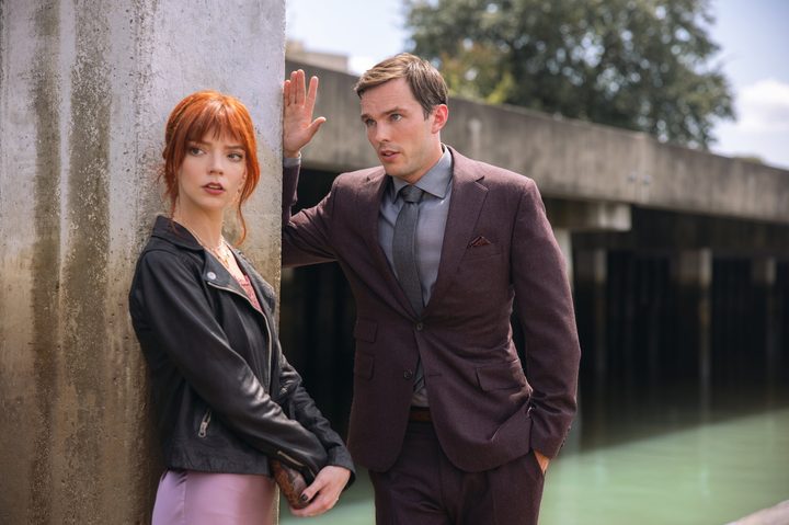Anya Taylor-Joy and Nicholas Hoult stand on a dock together in The Menu.