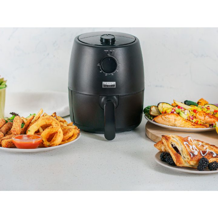 Bella Pro Series 2-quart Analog Air Fryer with sample dishes and appetizers.