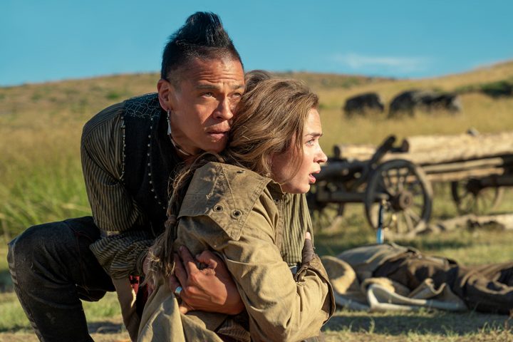 Chaske Spencer holds Emily Blunt in The English.