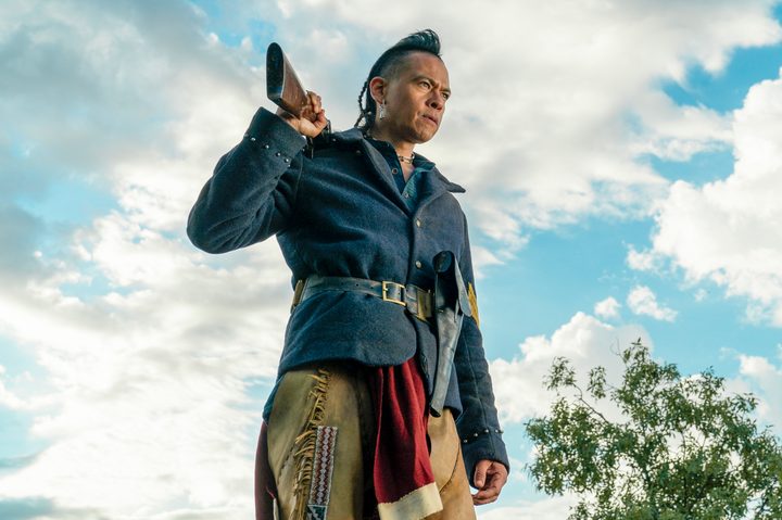 Chaske Spencer carries a rifle on his shoulder in The English.