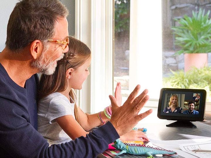 A father and daughter interact with family on their Amazon Echo Show 8.