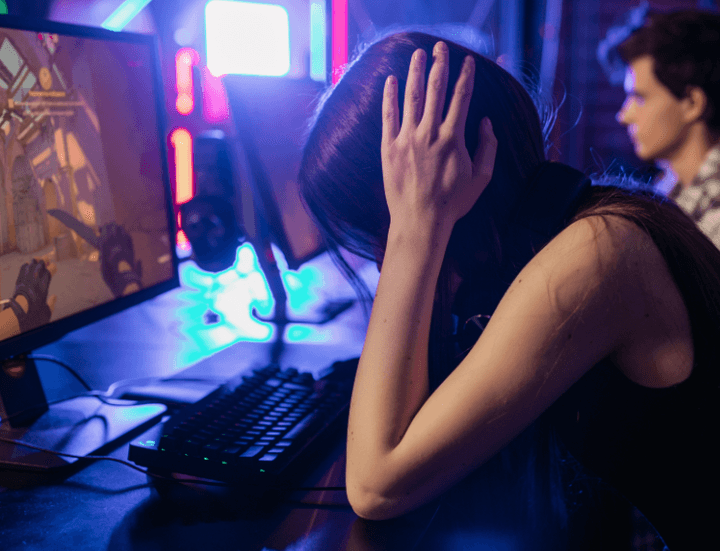 young woman with hands on head frustrated at game