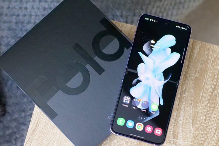 The Galaxy Z Flip 4 open on top of the Z Fold 4's box.