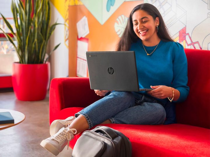 A young woman has a video chat on her HP 14-inch Chromebook.