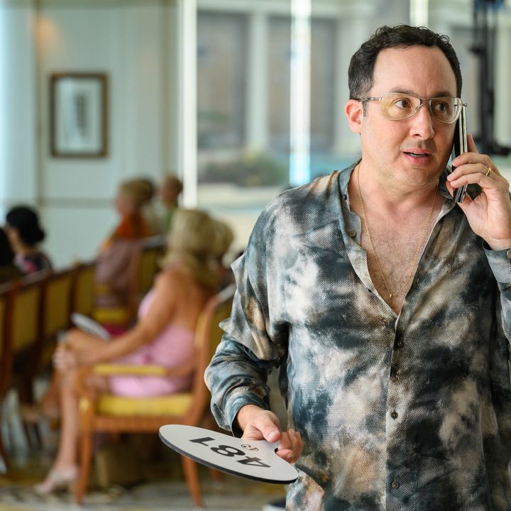 A man talks on the phone in a scene from Irreverent.