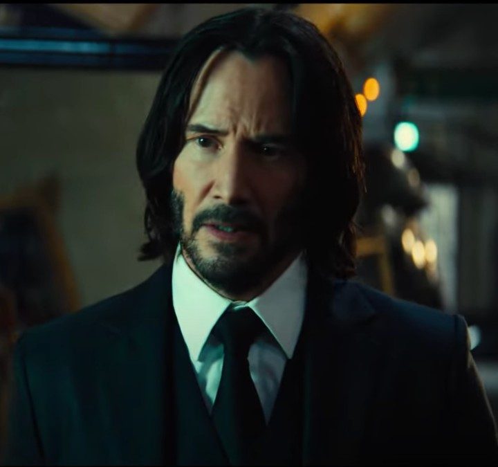 Keanu Reeves stares and walks in a scene from John Wick: Chapter 4.