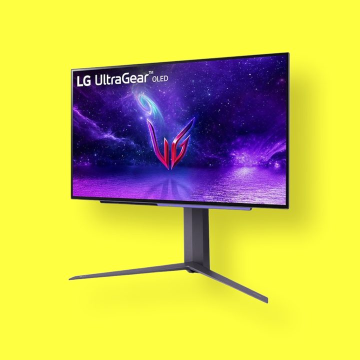 LG 27GR95QE front view over yellow background.