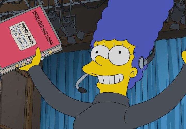 Marge is dressed in all black as she works on a play