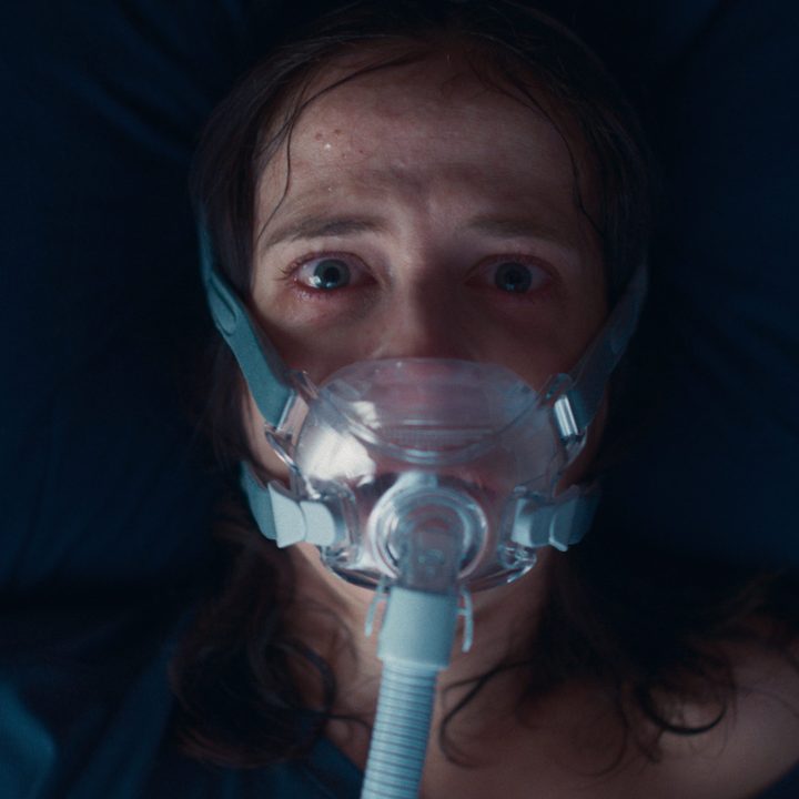 Eva Green with a breathing mask on her face in Nocebo.