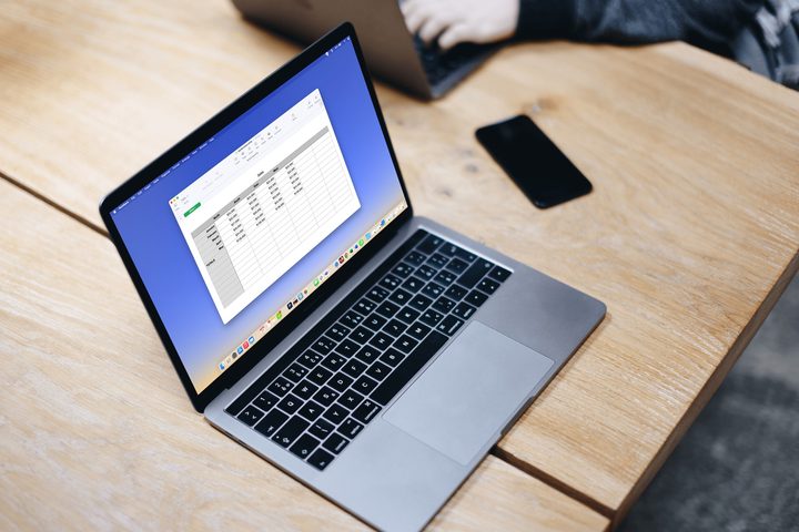 MacBook with Apple Numbers on a table.