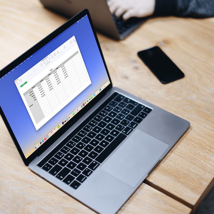 MacBook with Apple Numbers on a table.