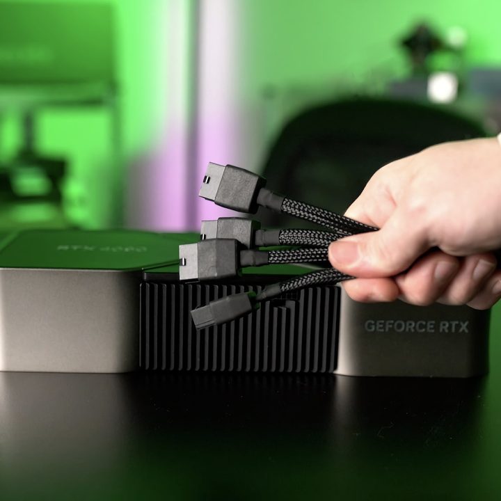 Nvidia GeForce RTX 4090 is shown along with a hand holding the power cable adapter.
