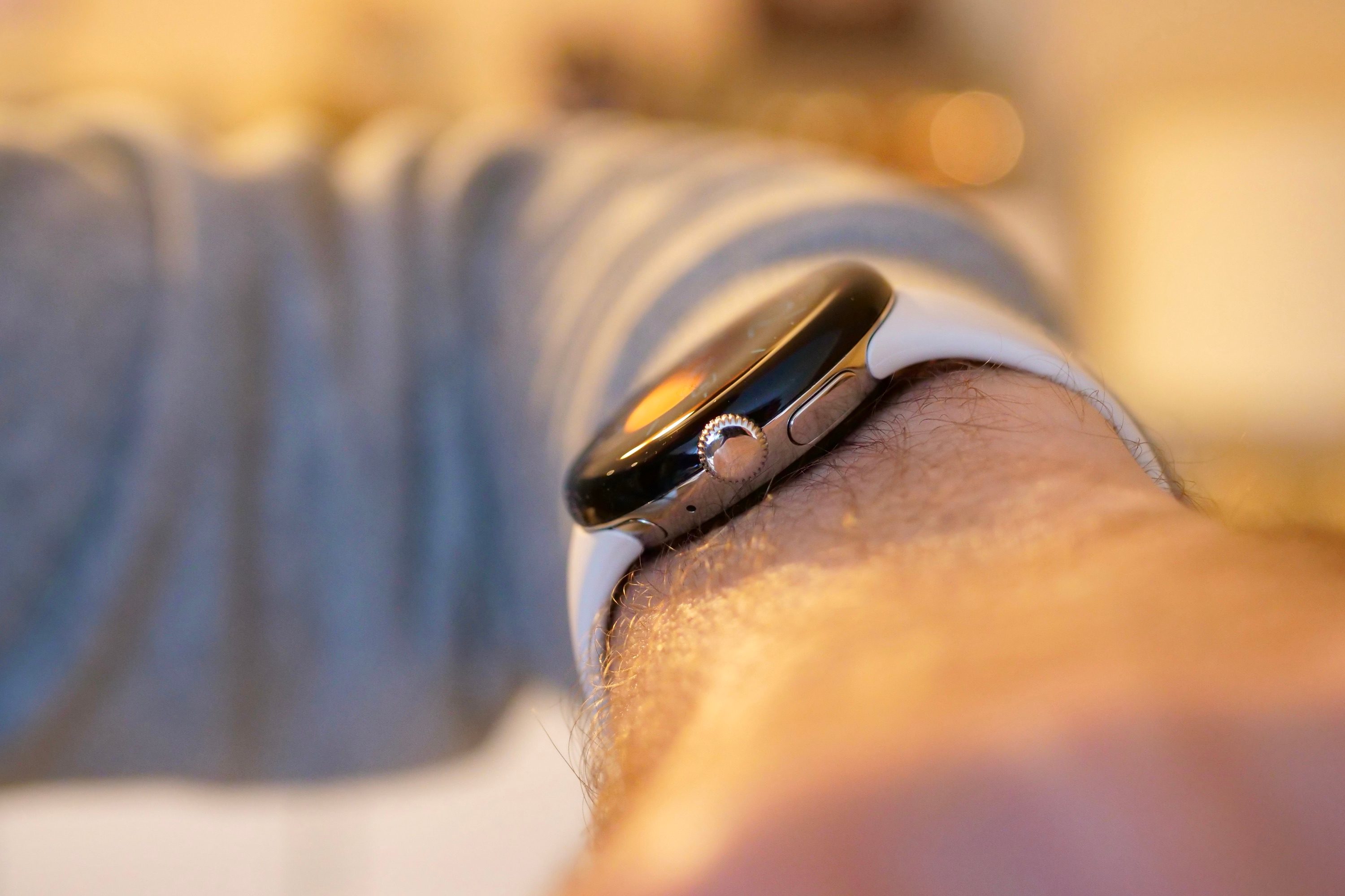The side of the Pixel Watch on a person's wrist.