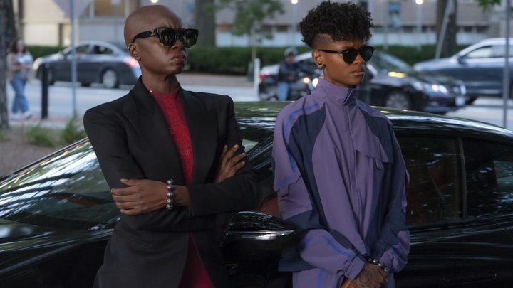 Shuri and Okoye stand alongside a car in Black Panther: Wakanda Forever.