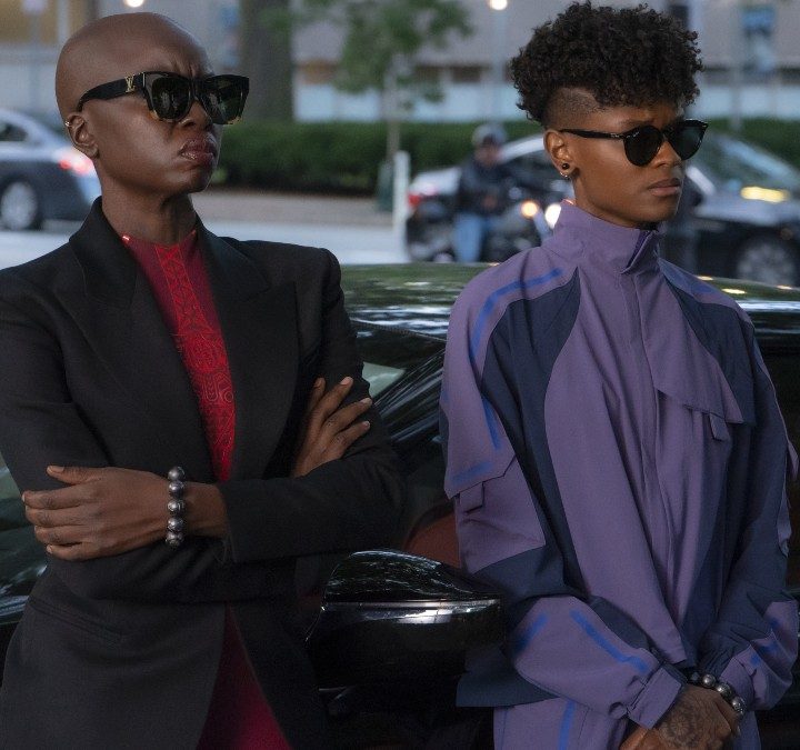 Shuri and Okoye stand alongside a car in Black Panther: Wakanda Forever.