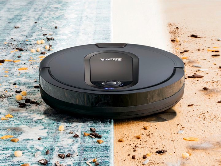 The Shark EZ RV912S robot vacuum cleans a carpet.