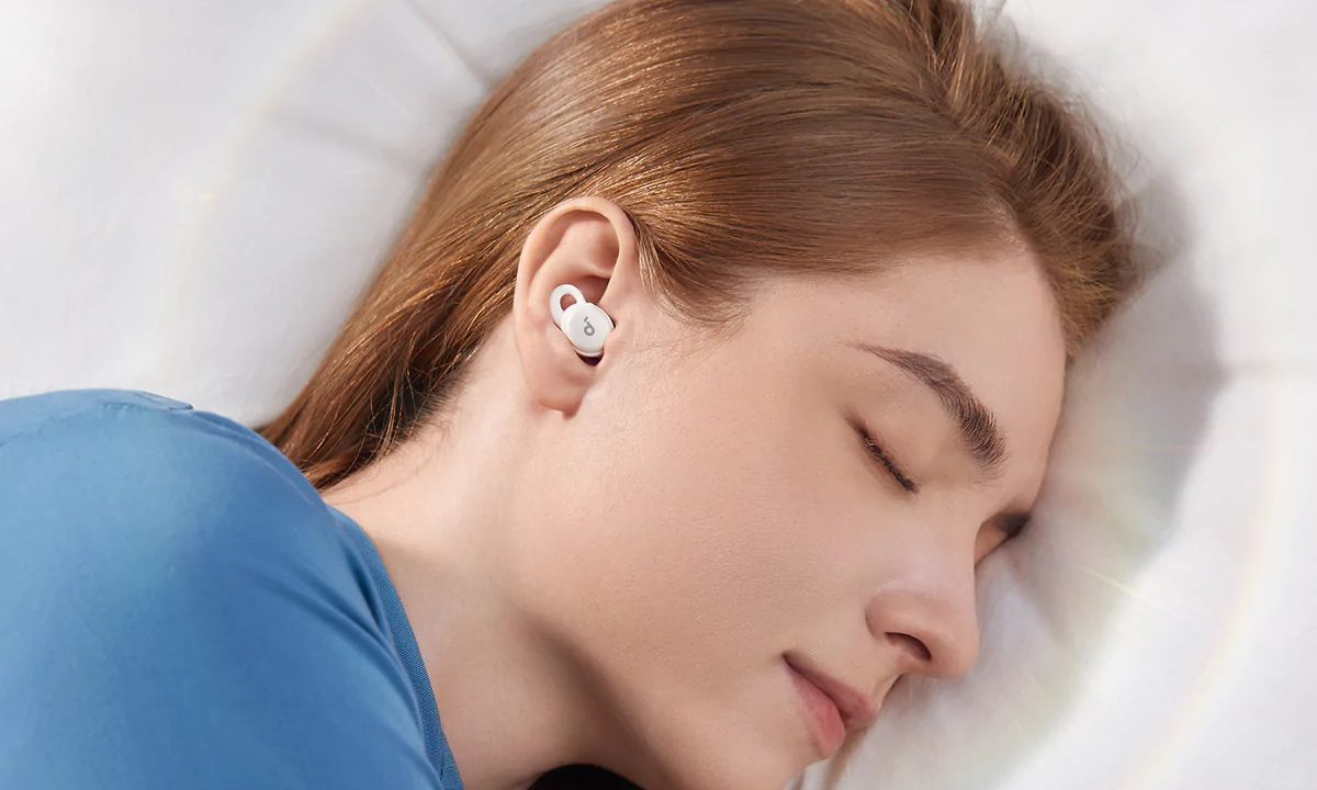 Woman sleeping with the Sleep A10 earbuds.
