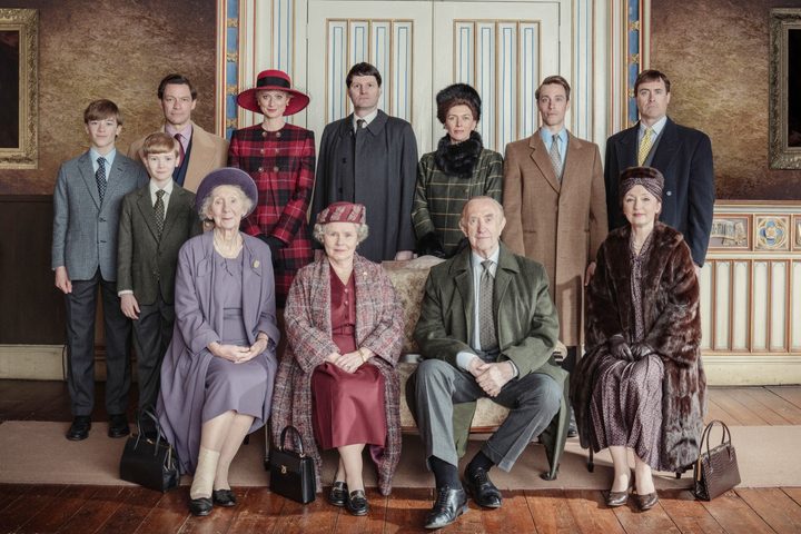 The Royal Family poses for a photo in The Crown.