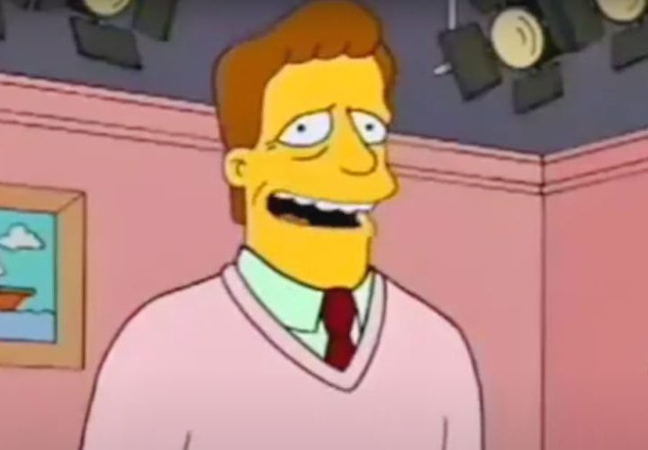 Troy McClure stands on a stage filming one of his many videos
