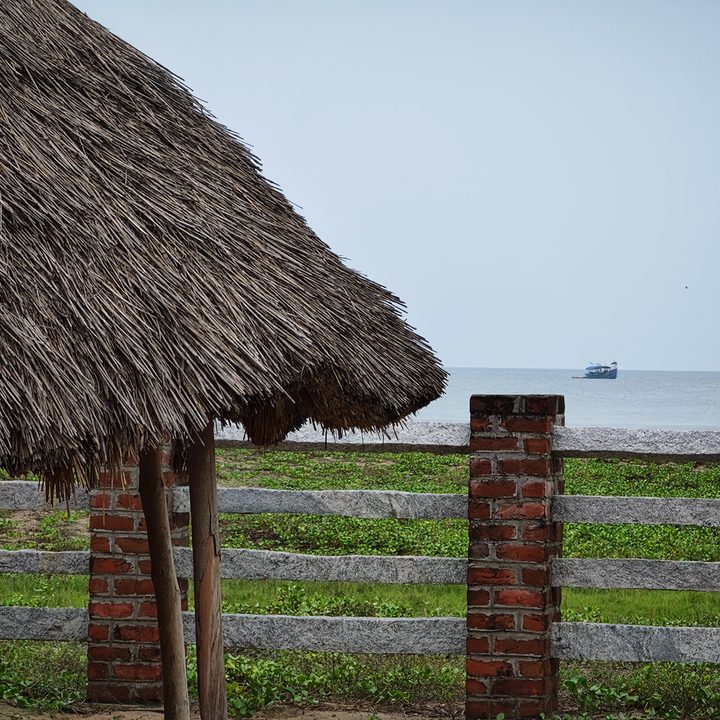 Thaw hut and wooden boundary in front of a sea front captured with the Xiaomi 12S Ultra.