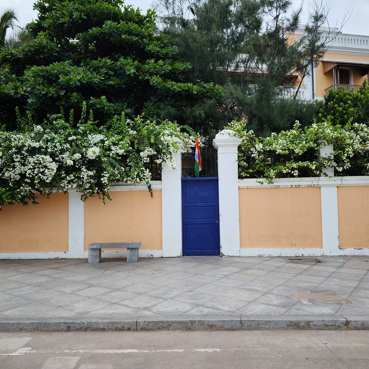 Property with cream walls, blue gate, and Indian flag captured with the Xiaomi 12S Ultra