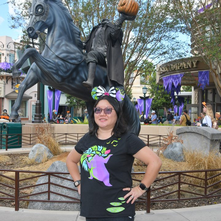 Christine poses in front of headless horseman statue at DCA.