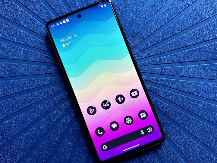 Google Pixel 7 rainbow gradient home screen on a blue placemat