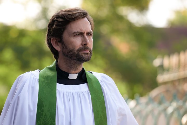 A priest looks in the distance in Inside Man.