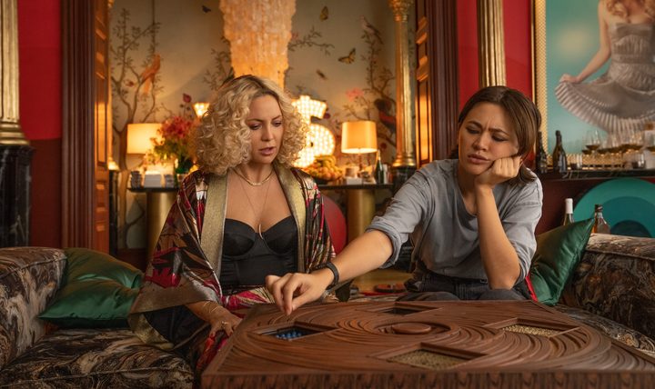 Two women try to solve a puzzle in Glass Onion.