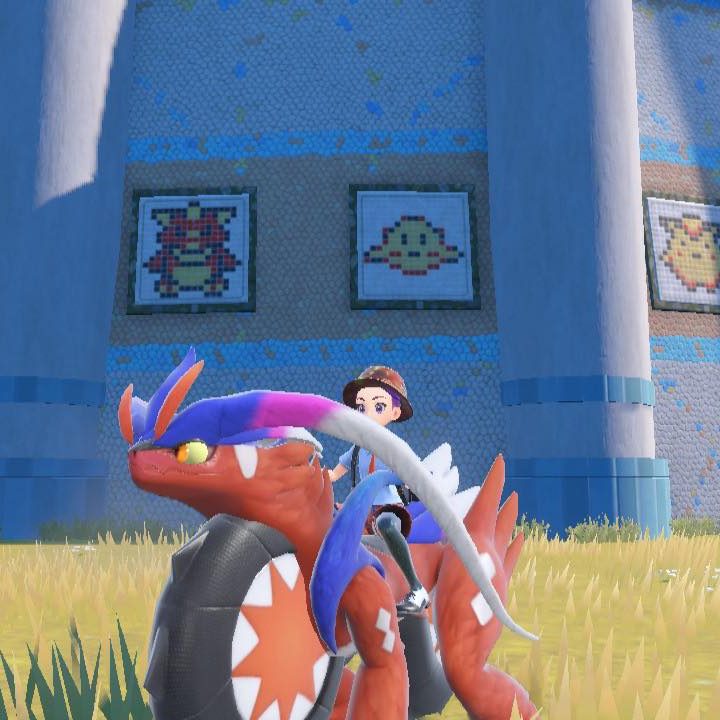A Pokemon trainer sits in front of a mural that references Pokemon Red and Blue in Pokemon Scarlet.