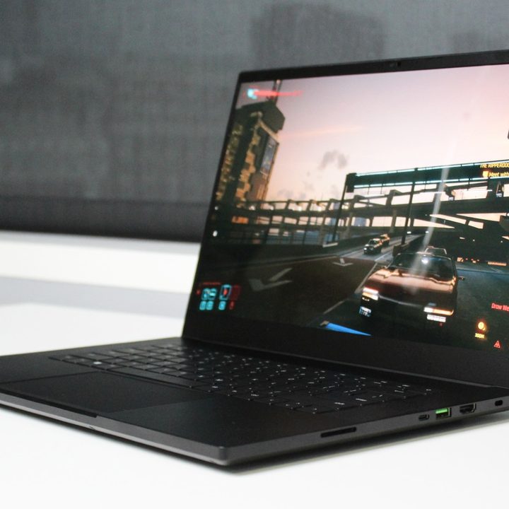 The Razer Blade 15 on a table with a game on the screen.