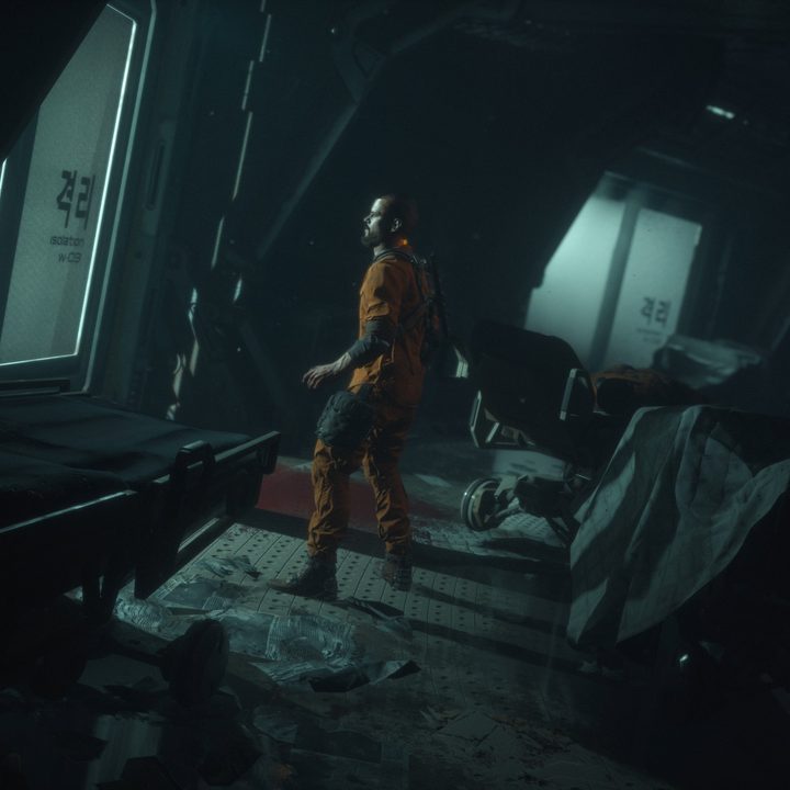 Jacob Lee stands in a dark hallway in The Callisto Protocol.