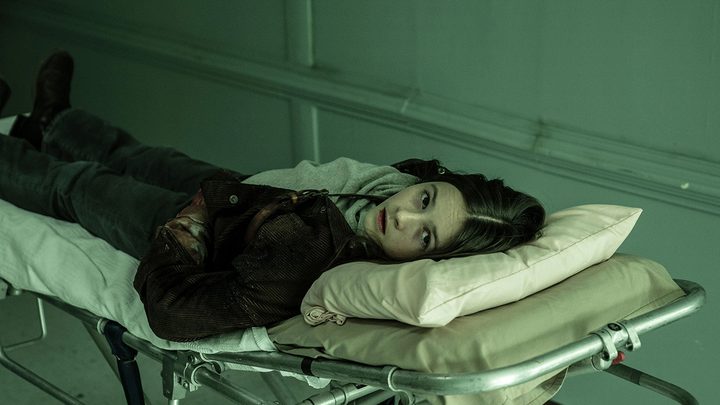 Judith lying on a hospital gurney in a scene from The Walking Dead.