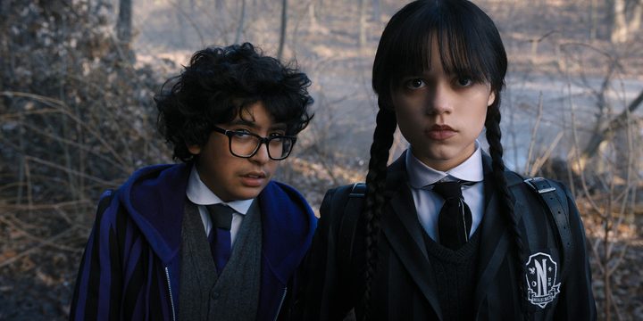 Moosa Mostafa and Jenna Ortega stare at the camera in a scene from Wednesday.