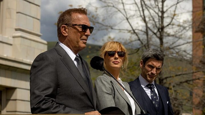 John Dutton stands next to his two children in Yellowstone.